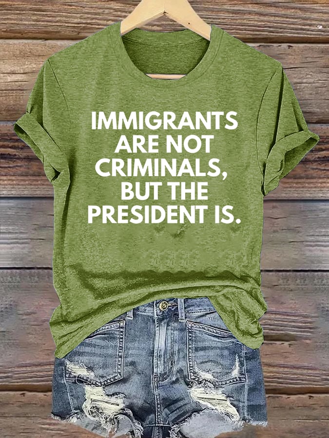 Women's IMMIGRANTS ARE NOT CRIMINALS, BUT THE PRESIDENT IS. T-Shirt